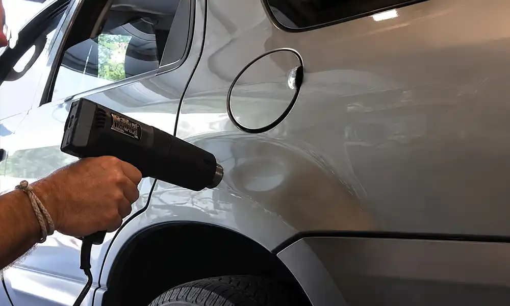 Hair dryer and compressed air DIY dent removal on car door