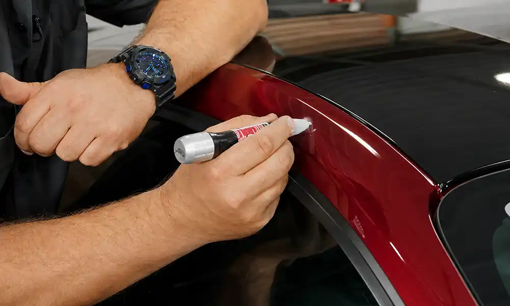 Manufacturer touch up paint pen application on Level 2 car scratch